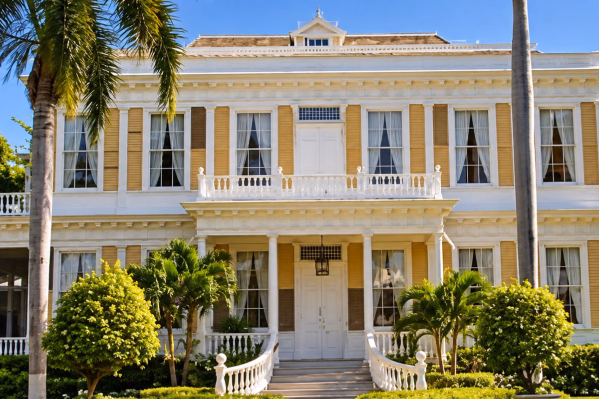 Front of Devon House with white balconies, gardens and palm trees