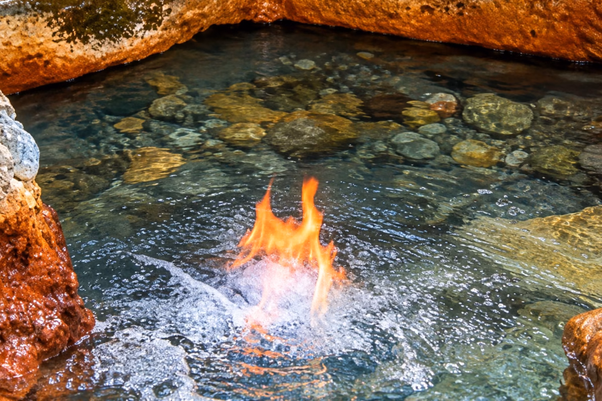 Flame burning on the water's surface at the Firewater Mineral Spring