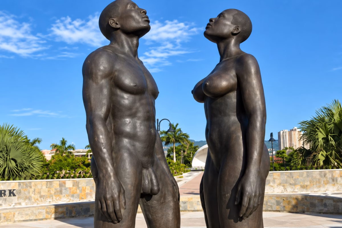 Bronze statues of a man and woman looking skyward at Emancipation Park