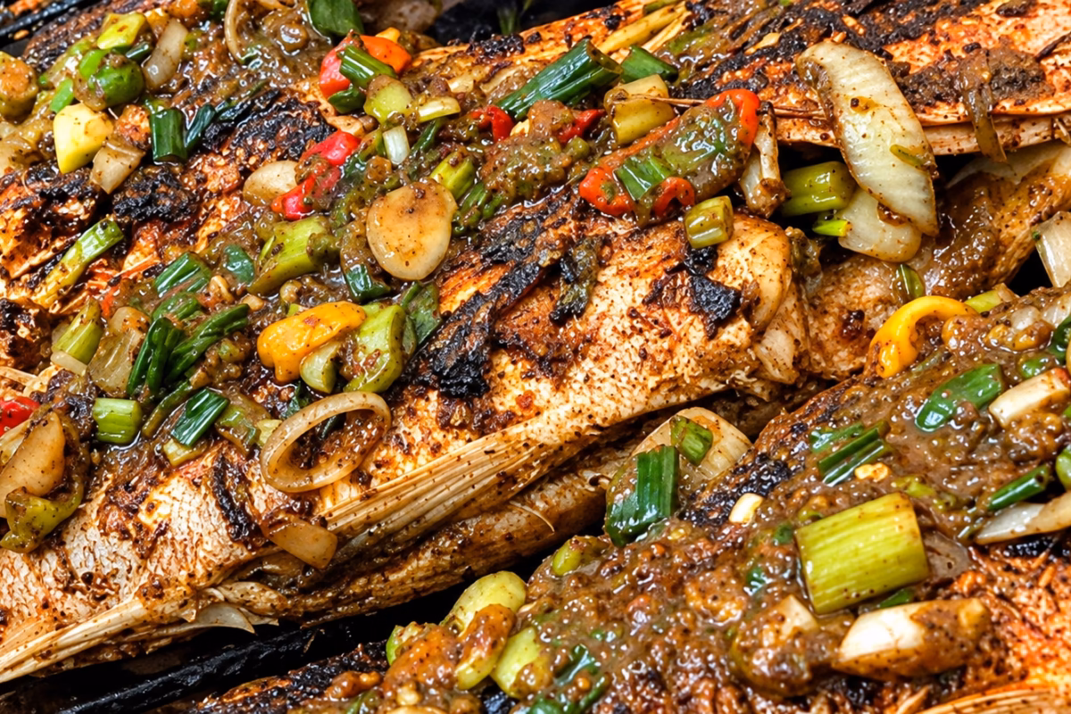 Grilled fish topped with scallions and peppers at Little Ochie