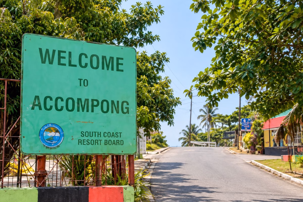 Welcome to Accompong sign beside the village road under a clear sky