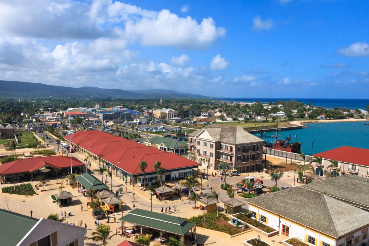 Aerial view of Falmouth's cruise port buildings with the sea and hills beyond