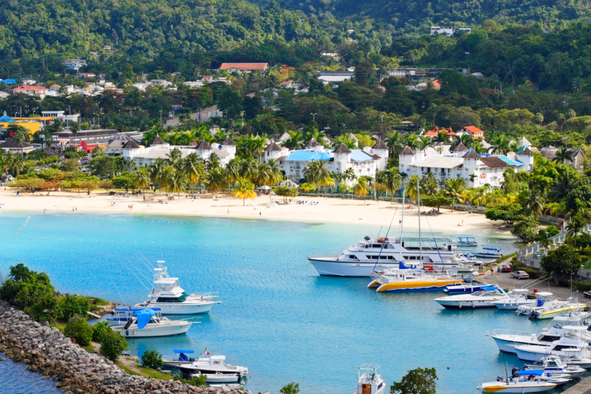 Ocho Rios beach and marina with yachts, hotels and green hills behind